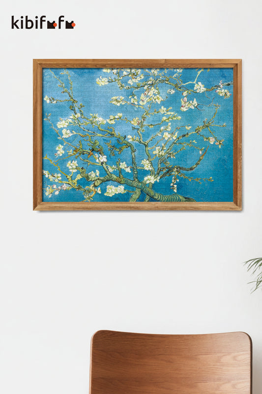 Framed artwork of a floral branch with a blue background on a white wall, featuring the brand 'kibifu'.