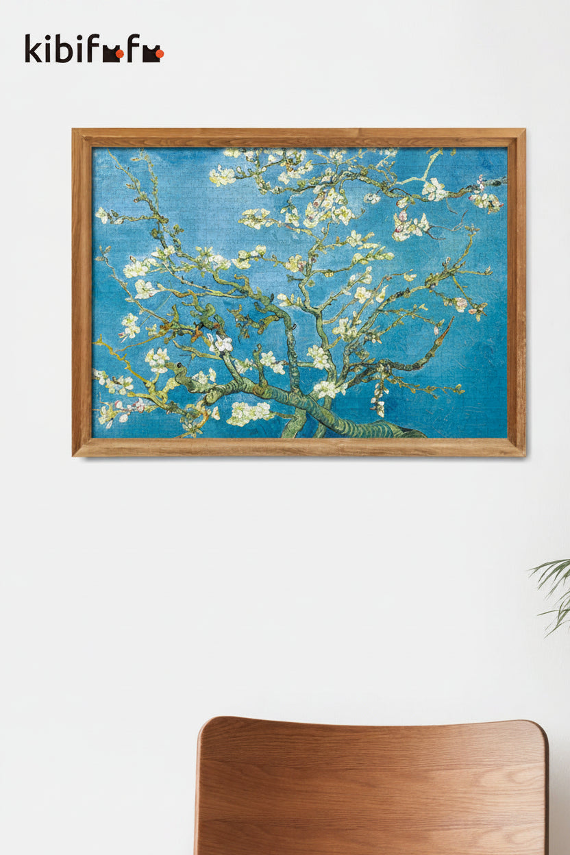 Framed artwork of a floral branch with a blue background on a white wall, featuring the brand 'kibifu'.
